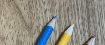 A blue, yellow, and red colored pencil